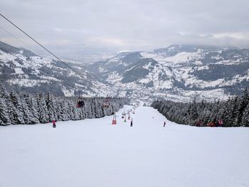 Aerial view of snow covered mountain against sky