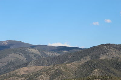 Scenic view of mountains against clear blue sky