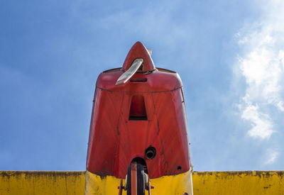 Low angle view of vintage red and yellow against sky