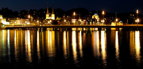 Reflection of illuminated buildings in water at night