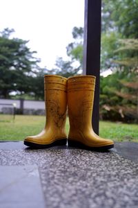 Yellow rubber boots at yard