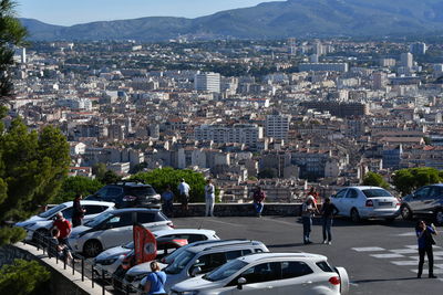 Vehicles on road by buildings in city