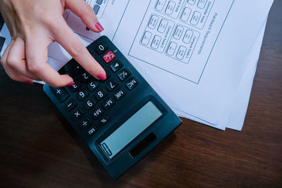 High angle view of man using mobile phone on table