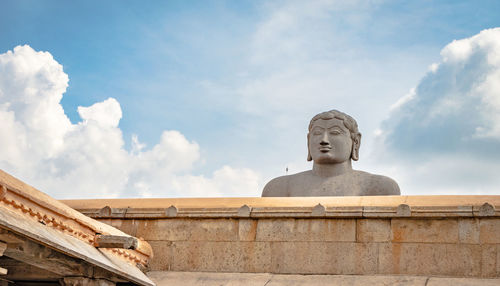 Low angle view of statue against cloudy sky