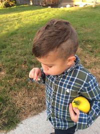 Close-up of cute boy blowing dandelion