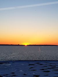 Scenic view of sea against orange sky