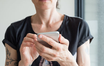 Midsection of woman using phone