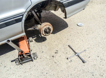 High angle view of jack under car on street