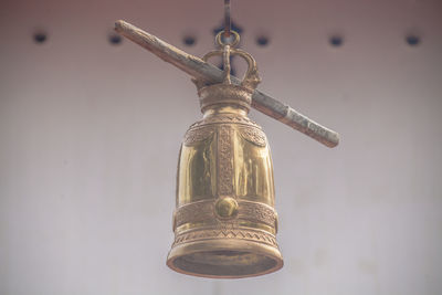 Low angle view of old electric lamp against sky