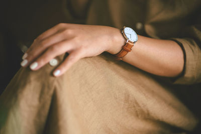 Midsection of woman wearing casuals and wristwatch