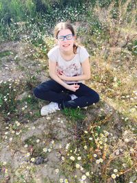 High angle view of woman sitting on grass