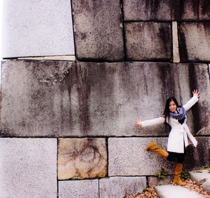 Woman standing on wall