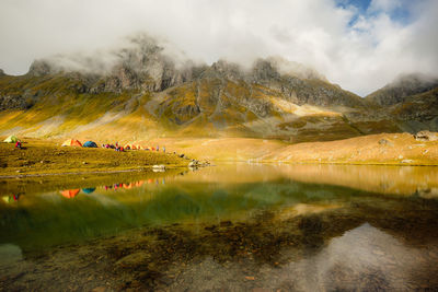 Scenic view of lake and mountains against sky