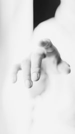 Close-up of hands against white background
