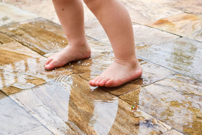 Low section of child on wet floor