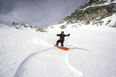 Person skiing on snowcapped mountain