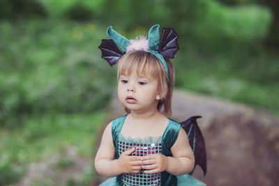 Portrait of young woman standing outdoors