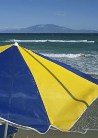 Close-up of yellow blue sea against sky