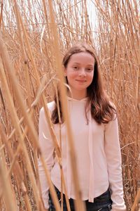 Portrait of smiling woman standing in field