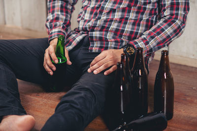 Low section of man sitting on floor