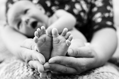 Close-up of baby girl lying outdoors