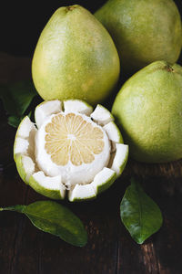 Close-up of pummelos on wooden table