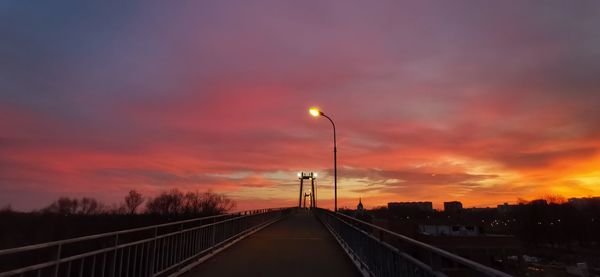 Street against sky during sunset