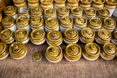 High angle view of ceramic china pots placed on a wooden table in a street shop in india