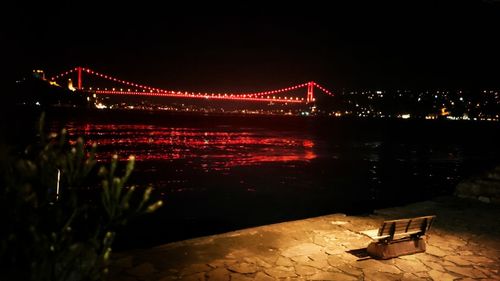 Illuminated suspension bridge at night