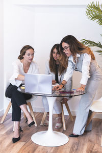 Lawyer with clients discussing over laptop in office