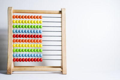 Close-up of multi colored abacus against gray background