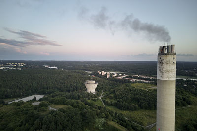 Landscape with factory chimney in foreground