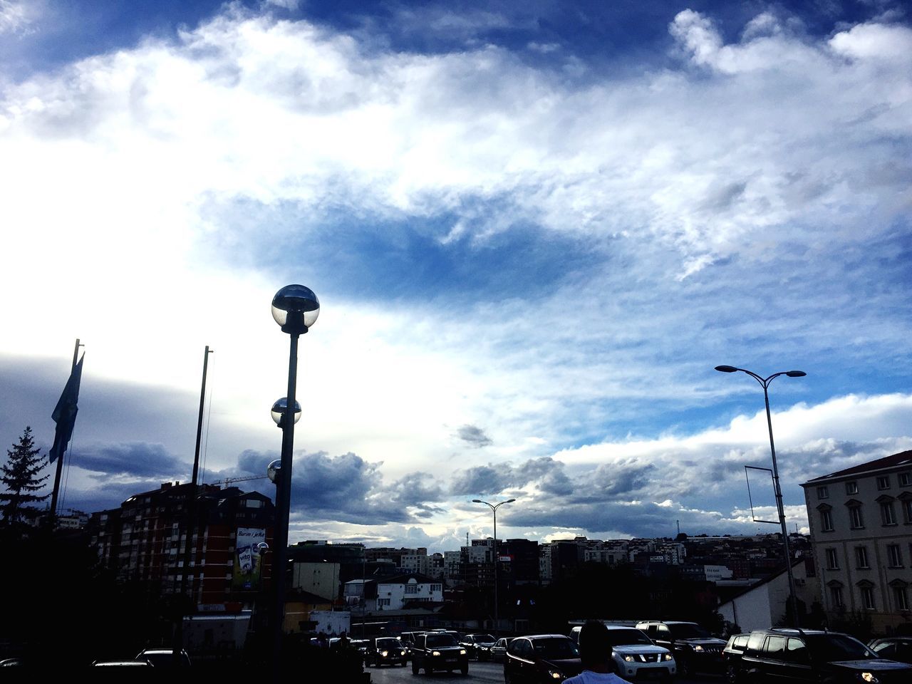 street light, city, sky, building exterior, built structure, architecture, cloud - sky, lighting equipment, cityscape, travel destinations, cloud, crowded, tall - high, city life, spire, blue, outdoors, skyscraper, cloudscape, scenics, tourism, modern, no people