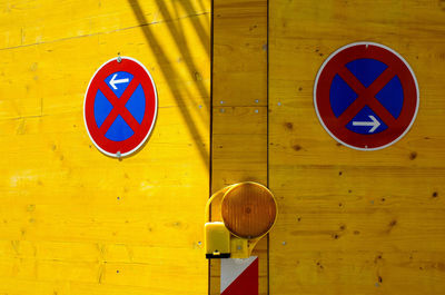 Close-up of arrow sign on wall