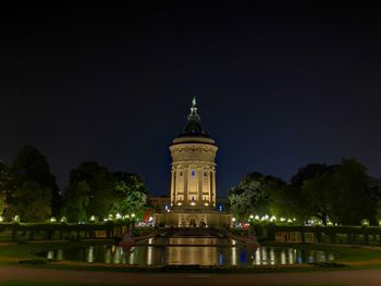 Illuminated building against sky at night