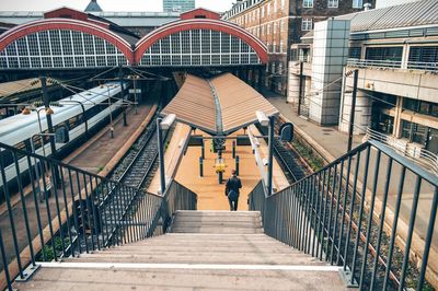 Rear view of man on staircase at railroad station