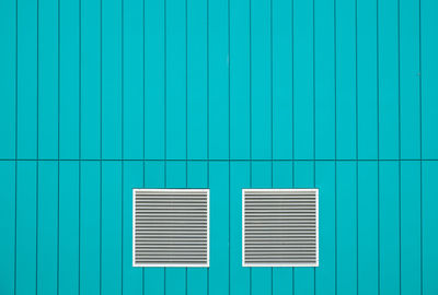 Windows on turquoise wall