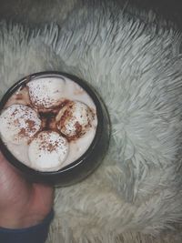 Close-up of hand holding coffee cup