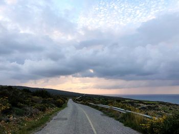 Empty road along countryside landscape