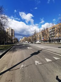 Road by city against sky