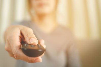 Midsection of woman using mobile phone