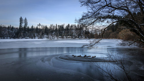 Scenic view of frozen lake against sky during winter