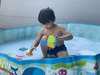 Boy playing in swimming pool