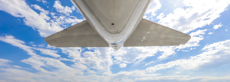 Rear view of jet airliner against blue sky