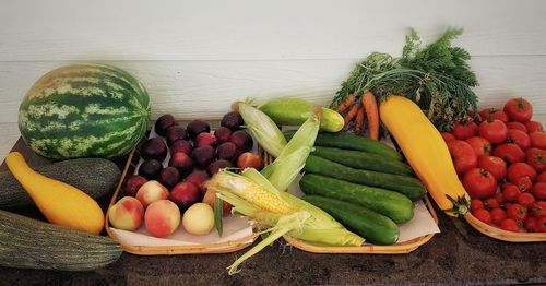 Vegetables and fruits in container on table