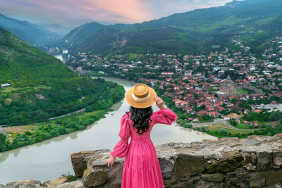 Rear view of woman standing on mountain