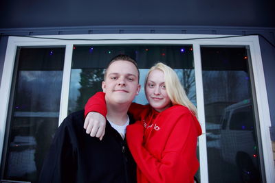 Portrait of young couple standing outdoors