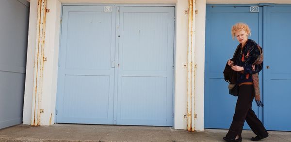 Woman standing by closed door