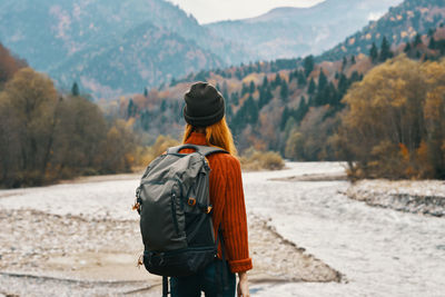 Rear view of woman looking at mountains