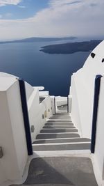 High angle view of staircase by sea against sky